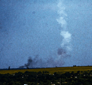 Enhanced versions of photo 1 and 2, showing the dark smoke culring up into the white plume. According to Bellingcat this feature showed the first stage exhaust of a BUK launch.